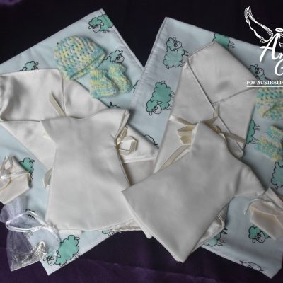 Two Angel Gowns packages with matching gowns, beanies, blankets, booties and keepsakes.